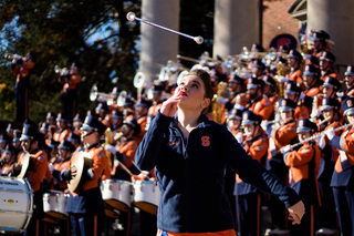 Abby Veccia, Syracuse University’s Orange Girl, twirls as the band opens their quad show performance with tunes played during pre-game. 