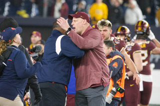 Coaches Dino Babers and P.J. Fleck congratulate each other on the game after the clock runs out of time. Minnesota won 28-20 after four quarters of regulation. 