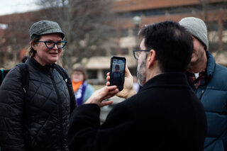 Mark Spadafore, the president of the Syracuse Labor Council, goes live on social media, documenting the event and the voices of different marchers. Many participants and passersby recorded the experience on their phones.