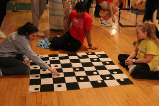 Syracuse University students play checkers with Rhyleigh, one of the Miracle Children. This year’s event featured lots of activities, such as games and ball pits, geared towards the children in attendance of the event.