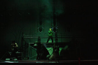 The Kid LAROI appears on stage amid a cloud of smoke and strobe lighting. The stage was set up to show three pit bulls in a cage where the rapper stood to open the show. 