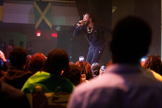 Gyptian creates a unity within the crowd by cuing moments for the group to jump or shine their phone flashlights. Pride from many different Caribbean countries decorated the auditorium, including a multitude of flags hung on the wall and over people’s backs.