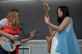 Sarah Kinsley and her guitarist play together on the stage in the middle of the Quad Friday afternoon. After her performance, Kinsley talked to and took photos with fans by the stage. 