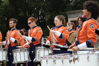 The Quad show is initiated with a drumline solo. The group was then joined by the entire band, which made their grand entrance with a march onto the steps of Hendricks Chapel.