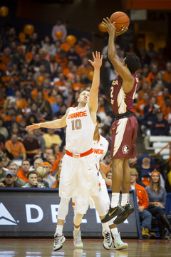 Florida State's Xavier Rathan-Mayes rises for a jumper over Trevor Cooney in the first half. The FSU freshman had two points in the opening half.