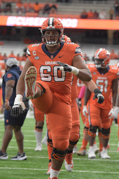 Hours before kick off, the Syracuse Orange is already in uniform and warming up on the field. Offensive lineman Matthew Bergeron focused his mind into the game as he did dynamic stretches. 