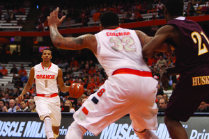 Michael Carter-Williams looks to pass as DaJuan Coleman jockeys for position against a Bloomsburg defender.