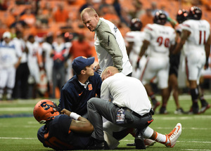 SU head coach Scott Shafer watches on as his starting quarterback Terrel Hunt is checked out by the Orange's medical staff during Syracuse's loss to Louisville on Friday night.