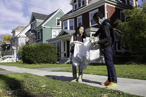 Kathy Chu, a sophomore biotech major, and Hamza Hasan, an architecture graduate student, pick up trash on Ostrom Avenue Sunday as part of Trash Pick Up Day. Students of Sustainability at SU and the Red Solo Cup Project sponsored the event, which will be held every Sunday throughout November.  