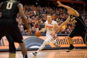 Trevor Cooney looks to dribble past Konstantinos Mitoglou on Tuesday night. The SU junior hit arguably the game's most important shot, and played a vital supporting role to Rakeem Christmas.