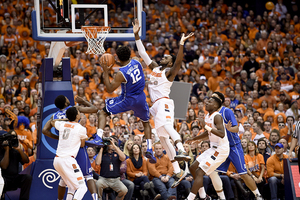 Duke's Justise Winslow goes up for a layup against Rakeem Christmas after penetrating the zone. It's something the Blue Devils did often on Saturday, and something Louisville can do as well on Wednesday.