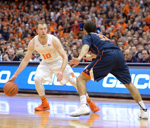 Trevor Cooney looks for an opening while being defended by Virginia guard London Perrantes. Syracuse jumped out to a 13-2 lead, but ultimately fell by 12 points.