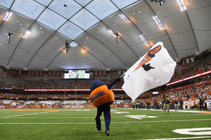 Otto the Oranges waves a flag bearing his own image before Syracuse's season-opener against Rhode Island.