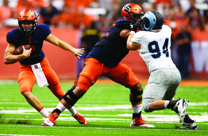 Eric Dungey (left) threw for more than 100 yards in his Syracuse debut, entering the game after Terrel Hunt tore his Achilles in the first quarter.