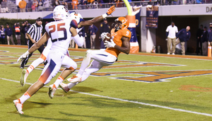 Virginia wide receiver Canaan Severin falls into the end zone after beating two SU defensive backs for a touchdown in overtime. The catch tied SU and UVA at 31 in the first overtime period.