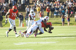 A Syracuse defender makes a tackle during the Orange's 44-38 loss to Virginia on Saturday. 