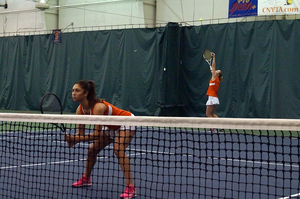 Gabriella Knutson serves during her doubles match against Virginia on Sunday. She won both her matches against the Cavaliers despite the team's 5-2 loss. 