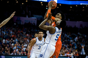 Oshae Brissett goes up to the basket over RJ Barrett. The sophomore added 14 points in the loss.