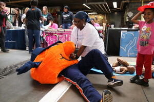 Brenda Muhammad, the executive director of FORCE, practices CPR on Otto as a part of its community preparedness work. 