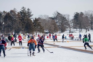 Syracuse residents brace single-digit weather as they join together at Hiawatha Lake.