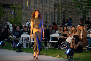 Models walk on the Quad pathways, showing off outfits to attendees. Student models showcased different sci-fi-inspired outfits as part of FADS' Neptune's Ball fashion show.
