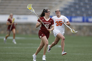 BC defender Sydney Scales collects a ground ball and carries it across midfield. Scales recorded a game-high five ground balls and won ACC Tournament MVP.