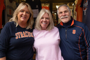 Wendy Hennessey, Sandra Jacobs and Dave Jacobs (left to right) stand in front of Shirt World — an independently-owned Syracuse University merchandise store. After 48 years, the store plans to close its doors.