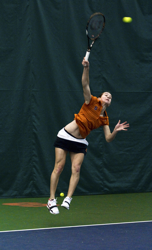 Emily Harman winds up to serve in the SU tennis teams match against Binghamton on March 12. Harman used her serve-and-volley attack once again to net a singles victory on Wednesday.