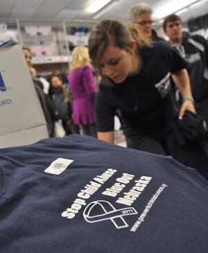 Courtney Coates, a junior and employee at McLanahans Student Store and Penn State Room, waits on a long line of  potential t-shirt buyers.