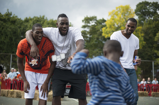 Members of the basketball team watch their opponents during the dance off. The players were guest judges at the event.