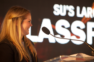 Chelsea Damberg, a 2012 SU graduate, announces the establishment of the Fisher Center, a new hub in New York City that will provide opportunities for SU students to study there.