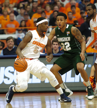 Syracuse forward C.J. Fair tries creating space on offense.