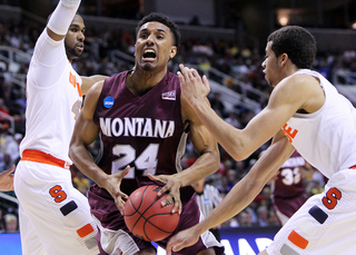 Spencer Coleman drives to the basket against James Southerland and Michael Carter-Williams.