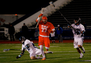 Henry Schoonmaker runs past Villanova attack Kevin Rice and long-stick midfielder John LoCascio. 