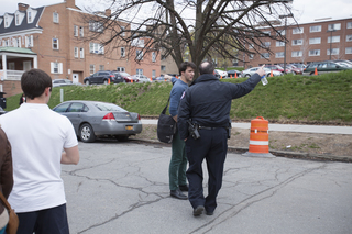 Seth Landau, a sophomore acting major, is turned away from Walnut  Ave by a DPS officer, Friday afternoon. DPS banned backpacks from the premise. 