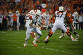 Syracuse quarterback AJ Long tries to recover the ball as it falls loose on the Memorial Stadium grass. 