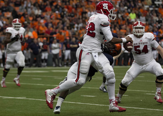 Franklin attempts to bring down Brissett as the quarterback scrambles to the right.