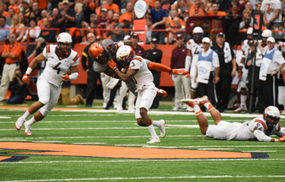 Amba Etta-Tawo catches a pass and is upended by defensive end Greg Stroman. Etta-Tawo caught five passes for 54 yards. 