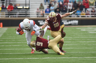 SU wide receiver Amba Etta-Tawo holds onto the ball while being tackled in the first half against the Eagles.