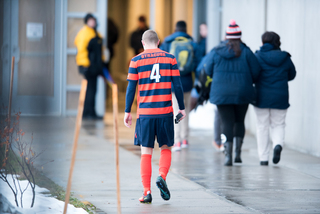 Senior Liam Callahan walks into the locker room at Onondaga Community College's Murphy Field. Sunday marked the final game in his college career.