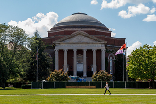 A student walks in front of Hendricks Chapel as work continues to replace the building's steps. This project is expected to be completed the first week of October. Photo taken Aug. 8, 2017