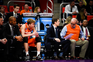 SU director of operations Kip Wellman (second from right) and trainer Brad Pike (far right) look onto the action. 