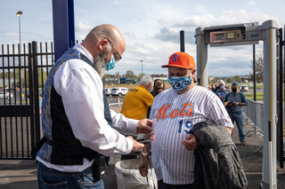 A fan goes through stadium security before entering NBT Bank Stadium to watch the game.